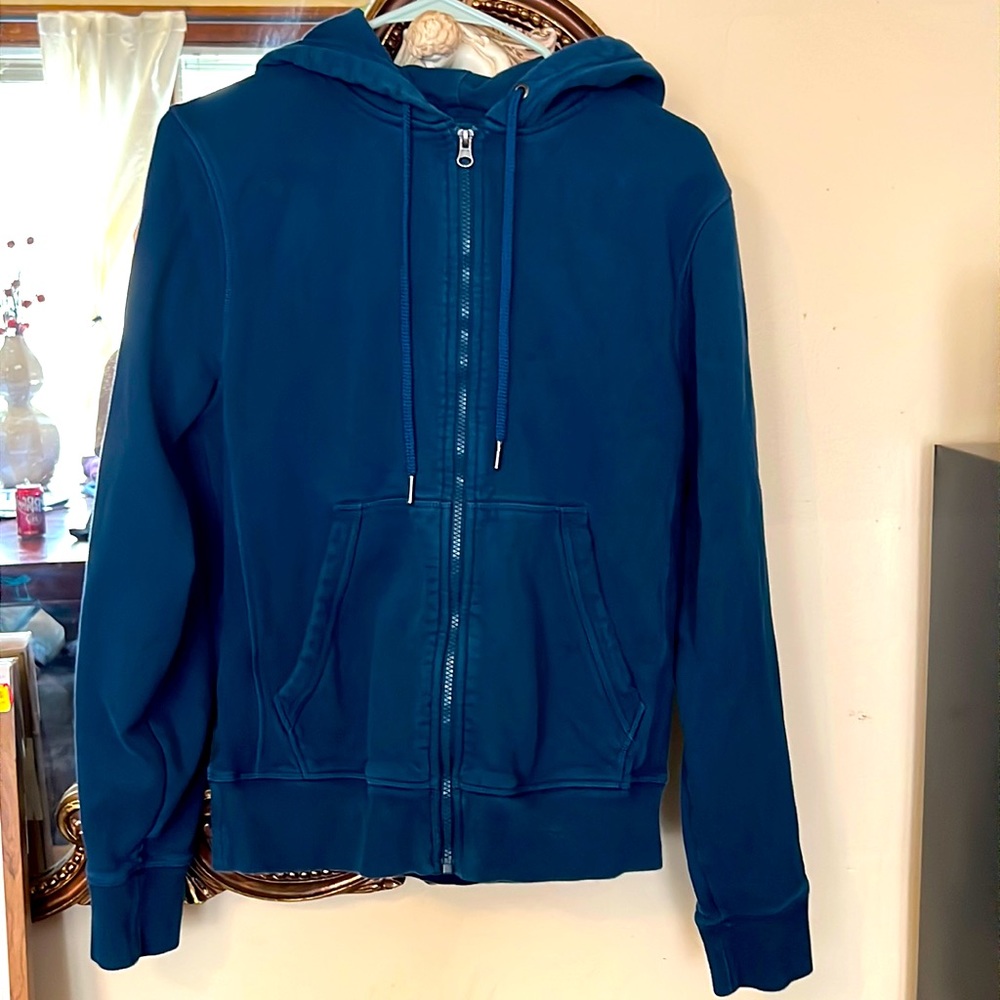 A blue sweater with a zipper, designed to keep you warm and in styled!